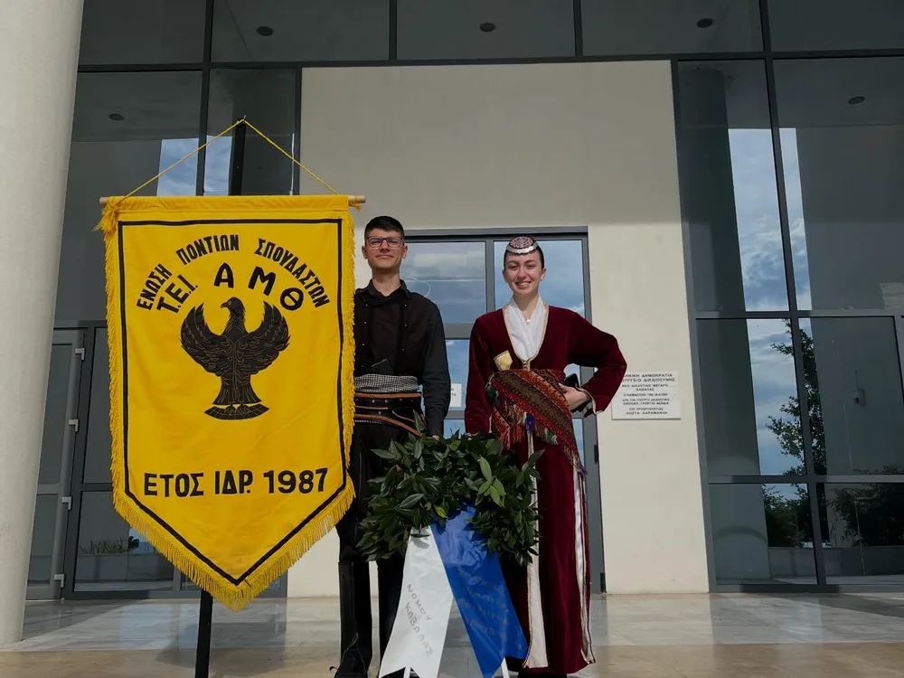 Δύο μέλη του Συλλόγου με ποντιακές στολές, το λάβαρο και στεφάνι για τη Γενοκτονία των Ελλήνων του Πόντου